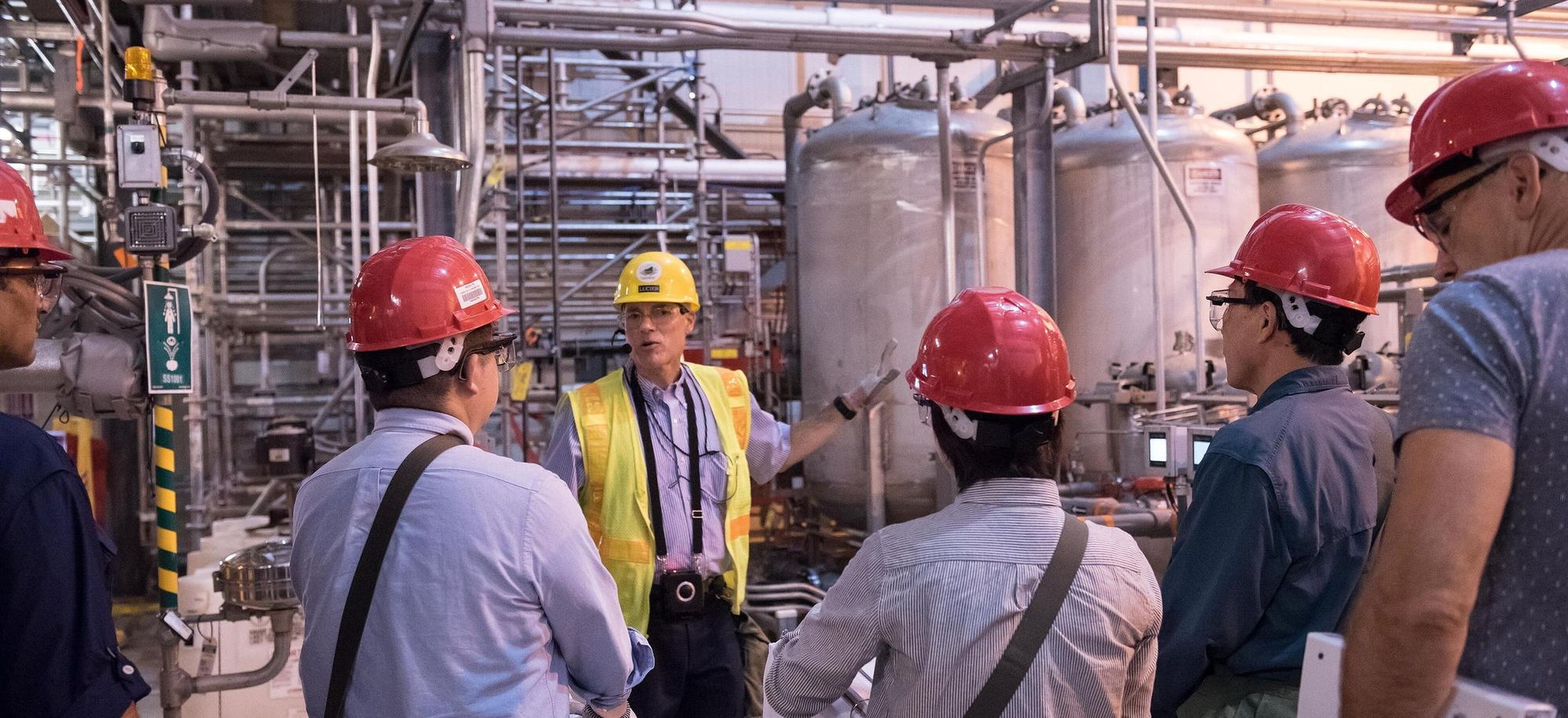 Engineers reviewing equipment in an operating facility
